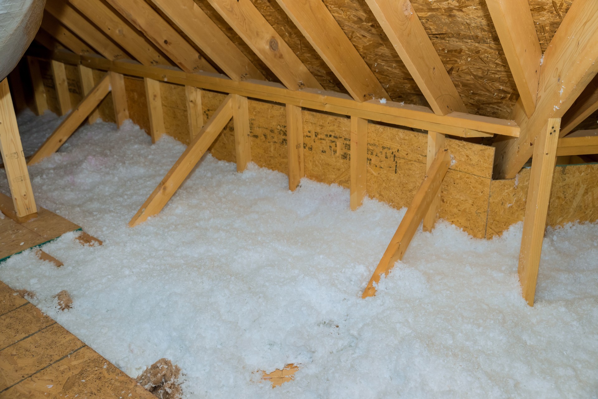 A new homes attic insulation roof is being poured with eco wool insulation for the purpose of insulating it